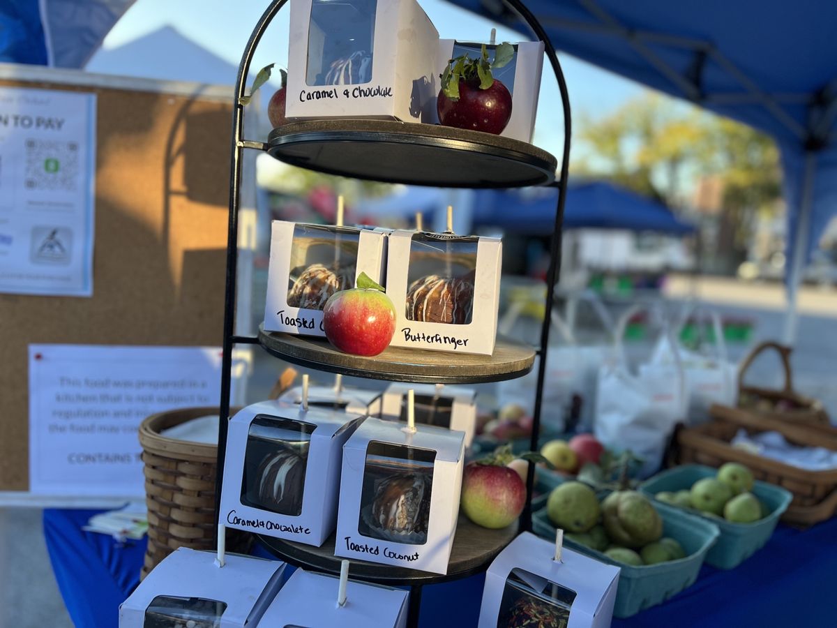 Caramel apples in gift boxes at the farmers market stand